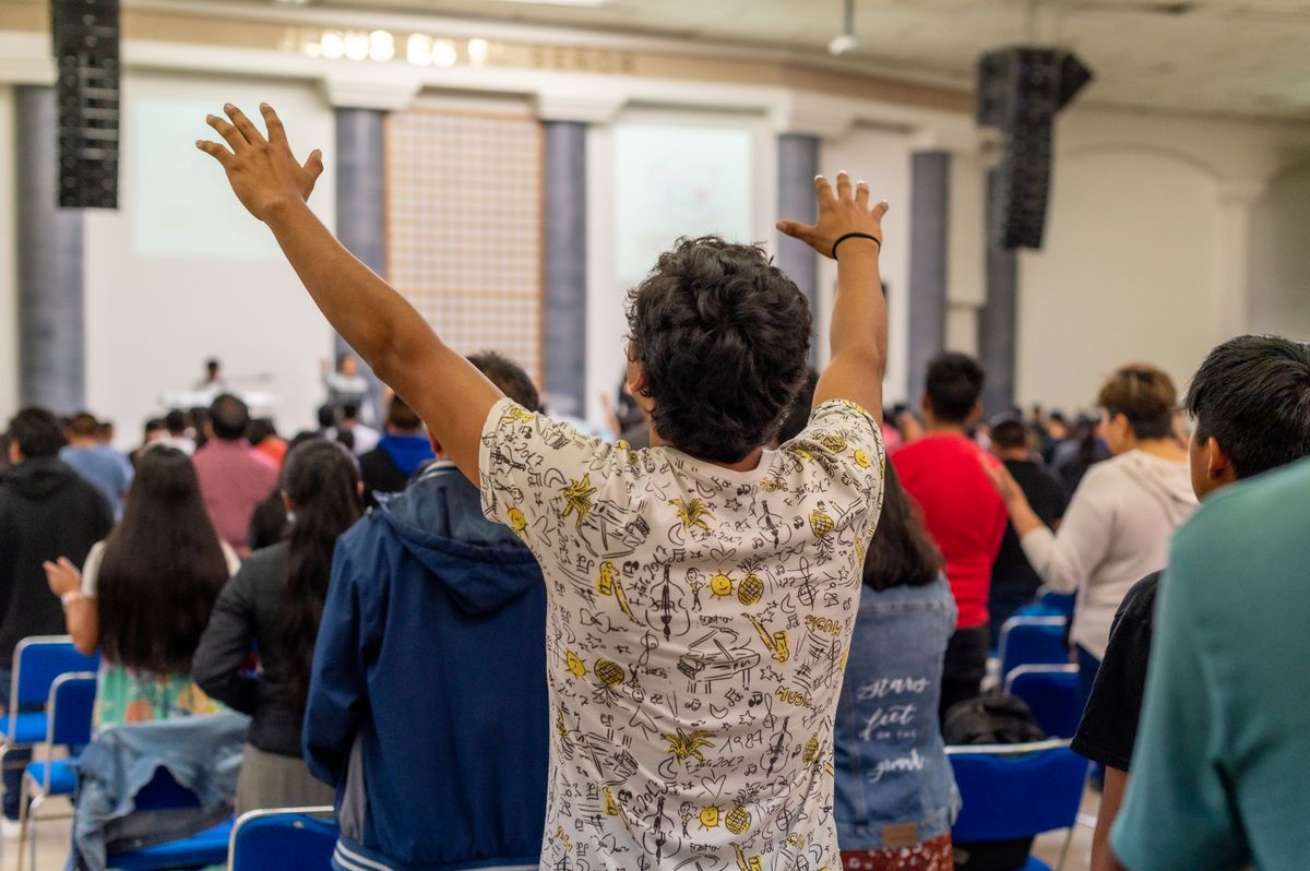 Men and women worshiping together at a church service